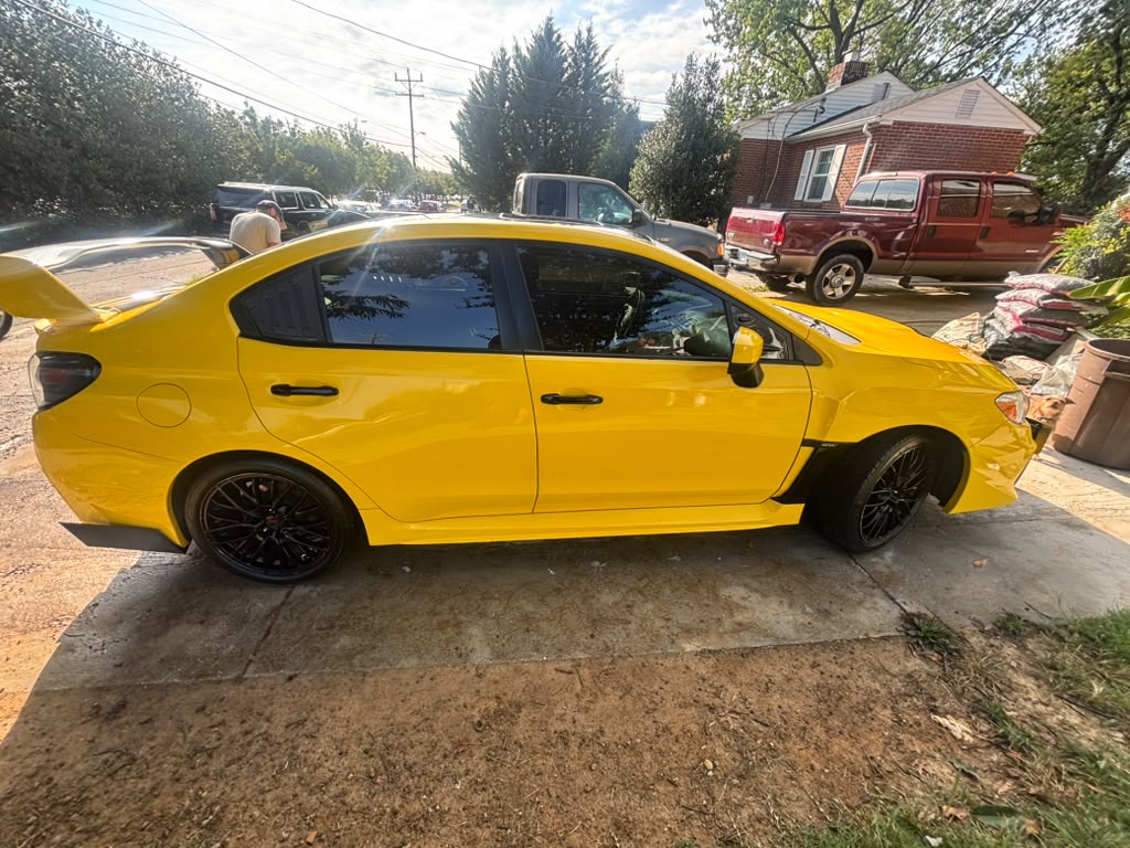 Yellow Subaru side view after mobile detail
