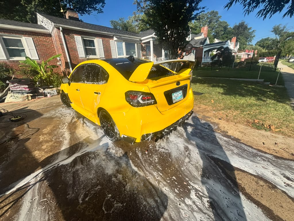 Yellow Subaru during exterior wash